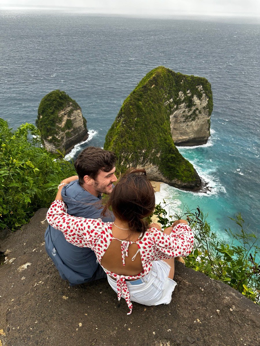 Oli and Vivi on a clifftop overlooking the sea